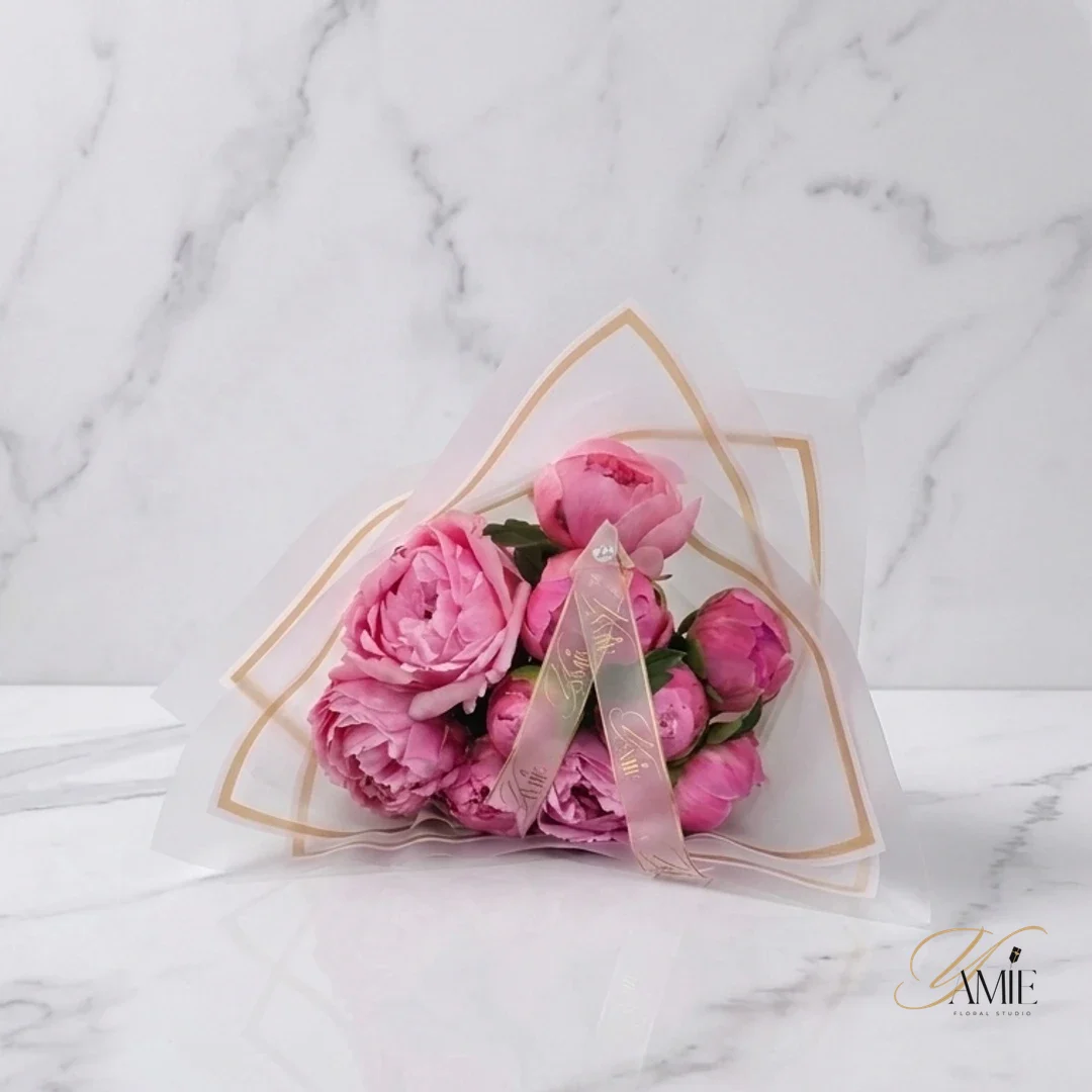 Pink peony bouquet in a sheer gold-trimmed wrap, Yamie Floral Studio
